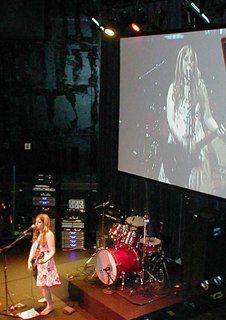 Brooke Trout performing live with a large video projection behind her!